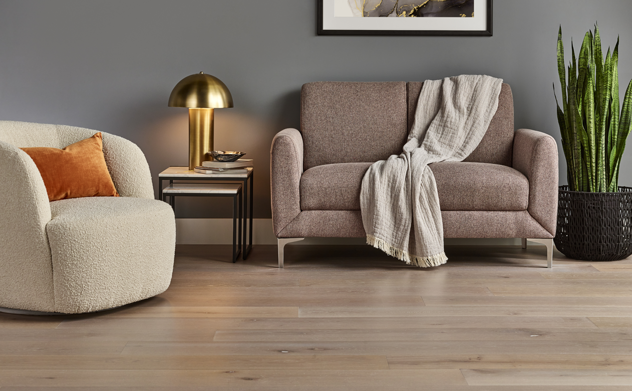 Medium hardwood planks living room with orange pillow 