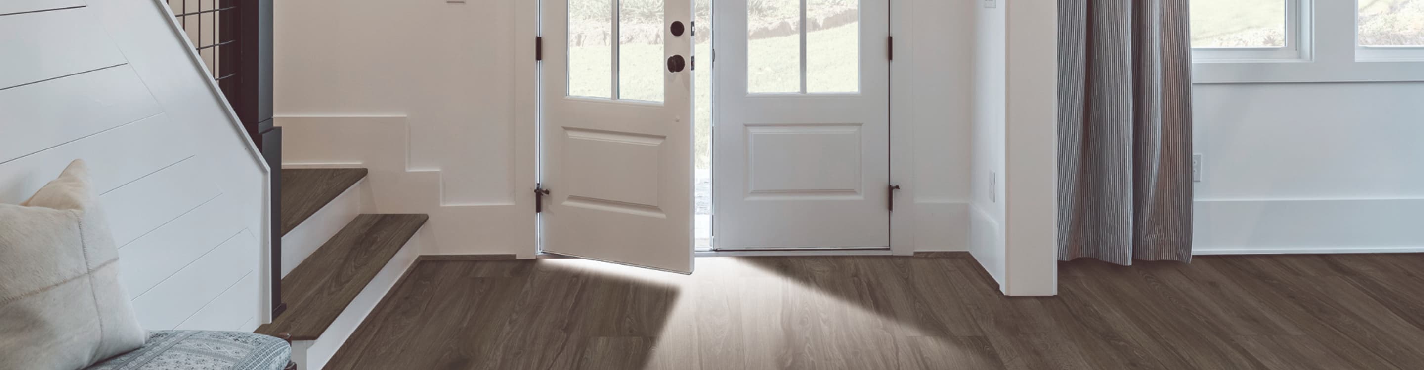 wood-look vinyl flooring in entryway and stairway