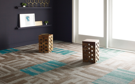 Grey, Cream, and Blue commercial carpet tile in a room with black walls and a white glass door